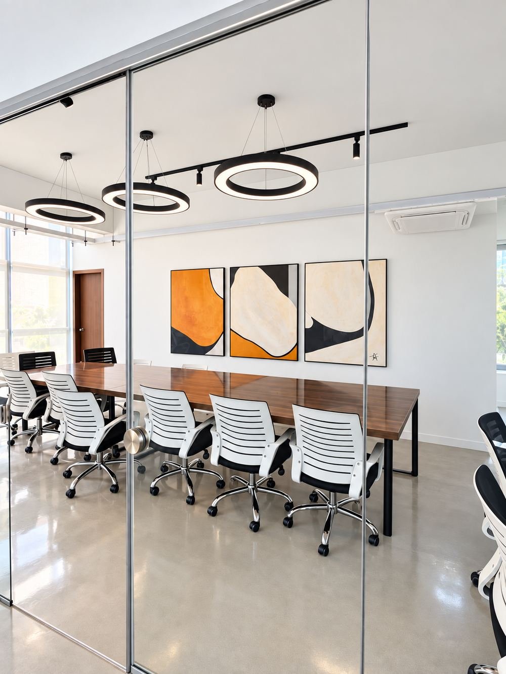 Sirkel boardroom with glass walls and circular pendant lights